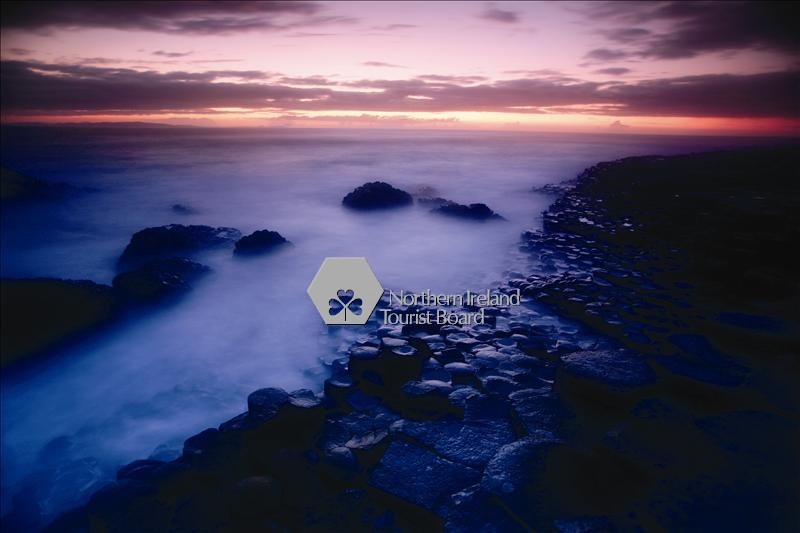 The Giant's Causeway is an area of about 40,000 interlocking basalt columns, the result of an ancient volcanic eruption. The tops of the columns form stepping stones that lead from the cliff foot and disappear under the sea.The tallest are about 12 metres (36 ft) high, and the solidified lava in the cliffs is 28 metres thick in places. It is located on the north-east coast of Northern Ireland, about 3 kilometres (2 miles) north of the town of Bushmills. It was declared a World Heritage Site by UNESCO in 1986.